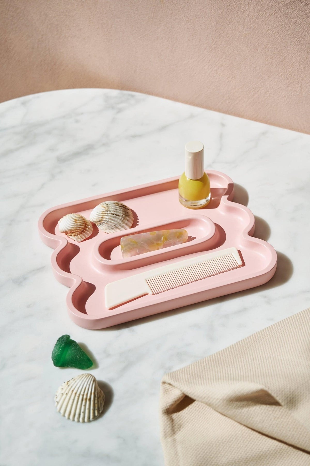 Pink Catchall Templo Wave by Octaevo—a resin tray with seashells, ideal for minimalist home decor.
