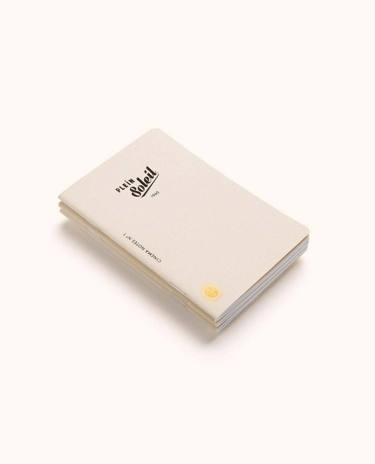 A minimalist white OCTAEVO Cinema Passport Notes (box of 3) with yellow seal, closed on a light beige surface.