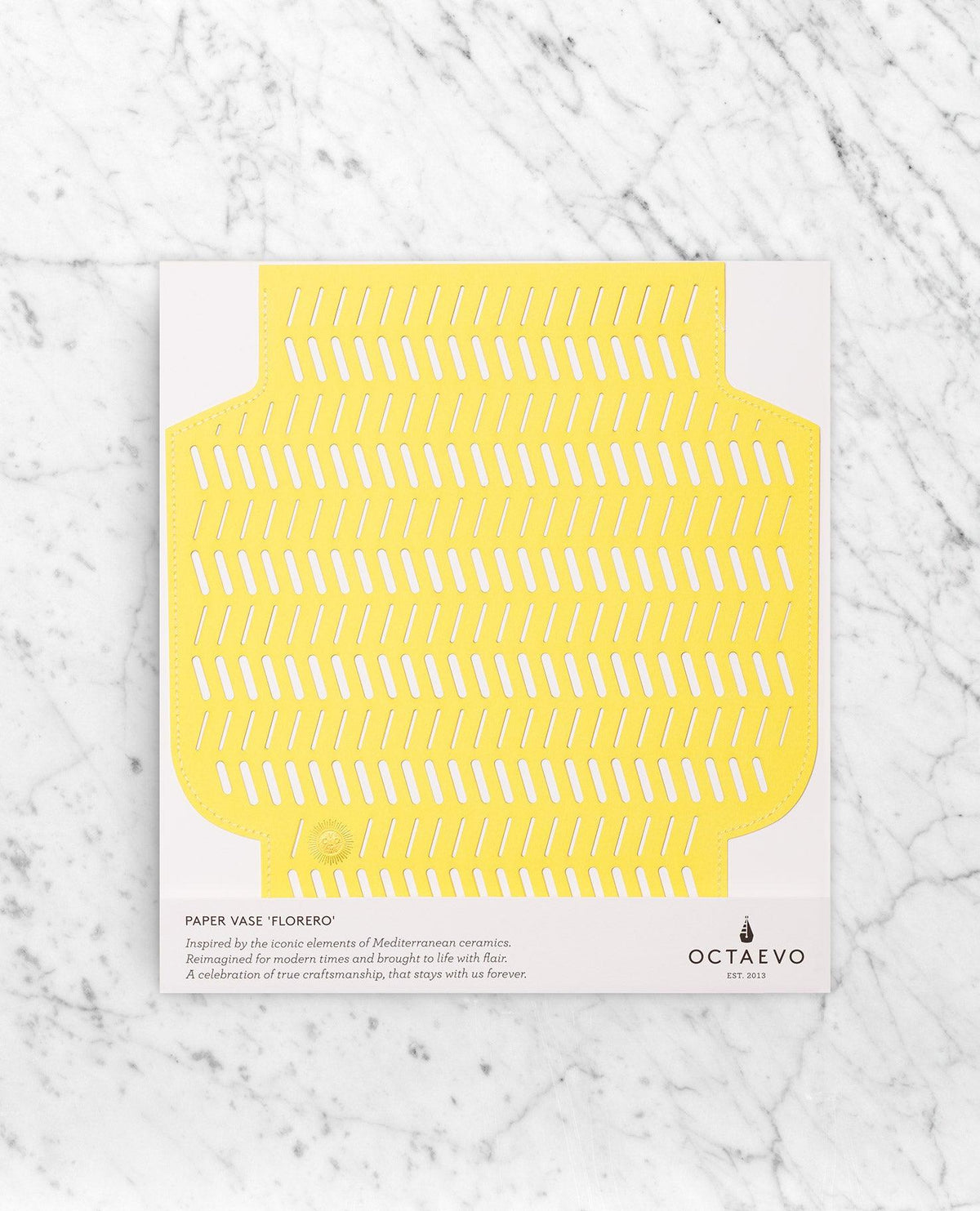 The Dendra Paper Vase by OCTAEVO features a flat, yellow, handcrafted flower design on a white card.