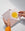Hands holding OCTAEVOs Greeting Card Bird featuring a yellow sun and gold bird on a light background.