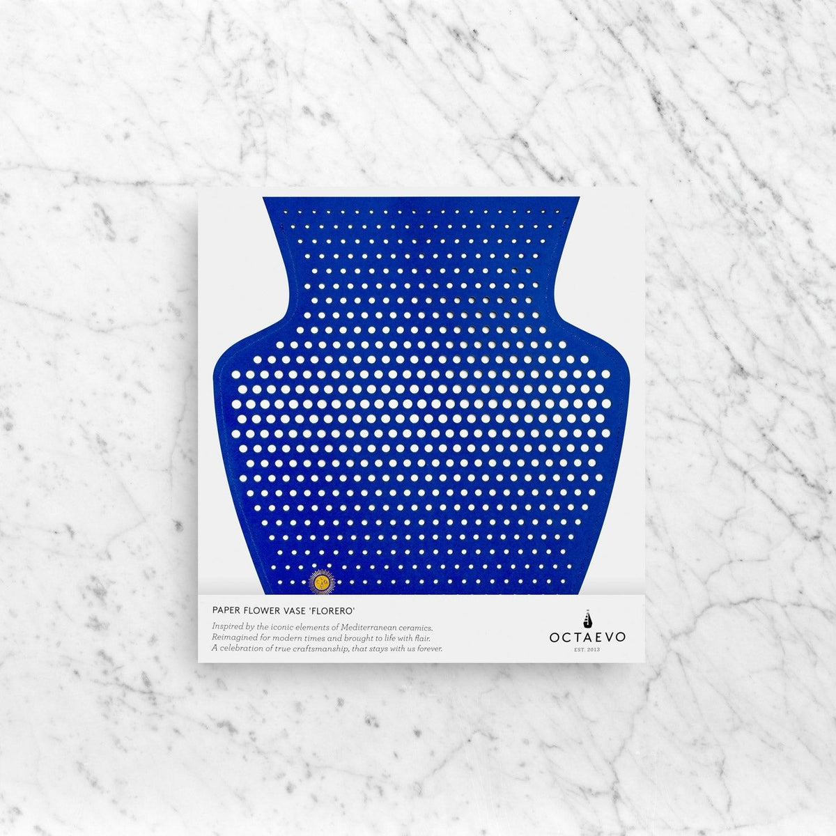 Blue Helio Paper Vase silhouette on white marble, with product info and OCTAEVO branding at the bottom.