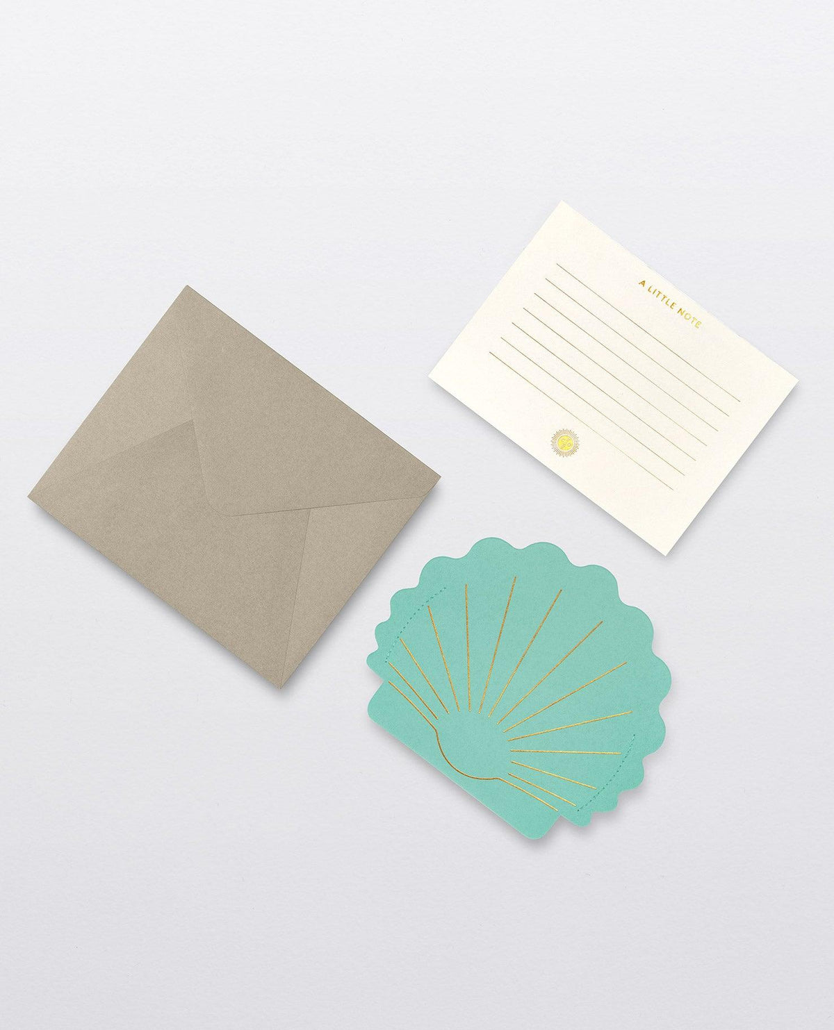 OCTAEVO Hera Mini Paper Vase with a brown envelope, lined notecard, and teal shell card on a light gray surface.