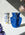 Two OCTAEVO Jaime Hayon Paper Vases, one white and one blue, feature vivid abstract faces.