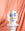 Janus Paper Vase by OCTAEVO in white with blue abstract face and gold cheeks, displayed on a white pedestal.
