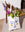 The Janus Tote Bag by OCTAEVO features a blue and gold abstract face and flowers, crafted from organic cotton.