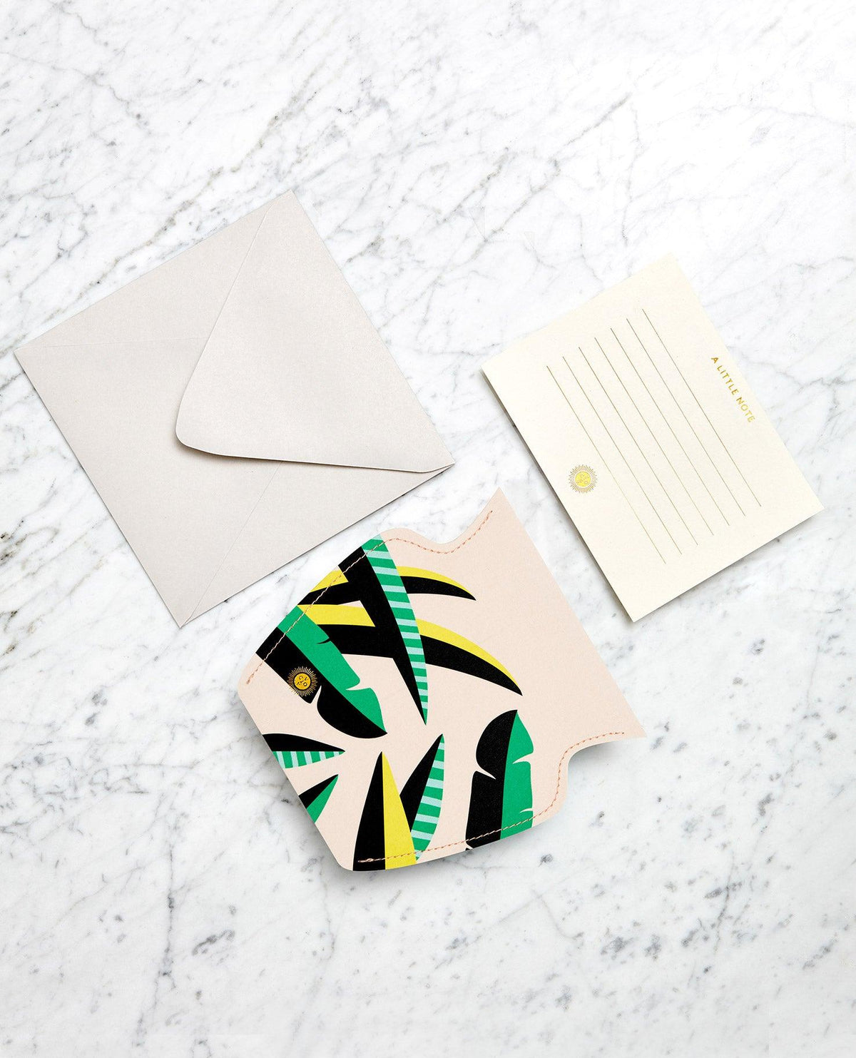 OCTAEVO Le Club Paper Vase beside a beige envelope and note card, displayed on a marble surface.
