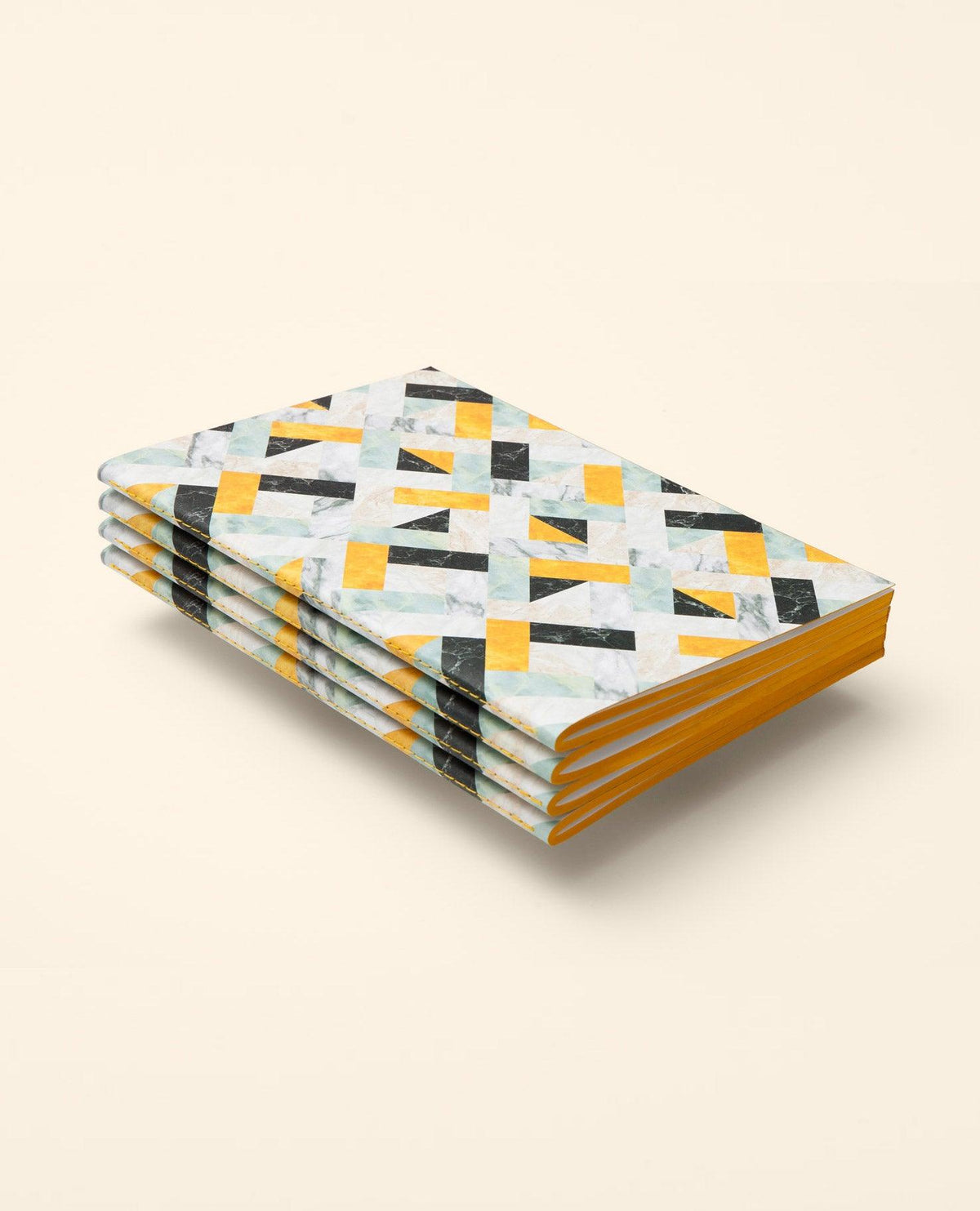 Stacked OCTAEVO Marble Notes with geometric yellow, black, and gray covers and yellow-edged pages.