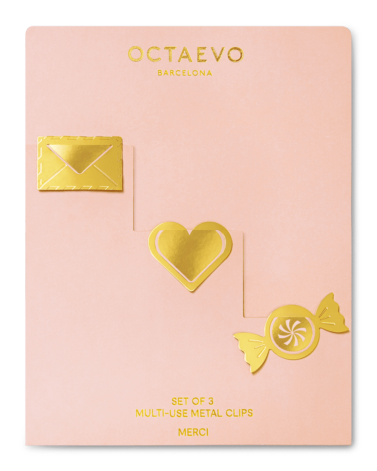 Gold metal clips—envelope, heart & candy shapes—on a pink card. Metal Clips Merci by OCTAEVO.