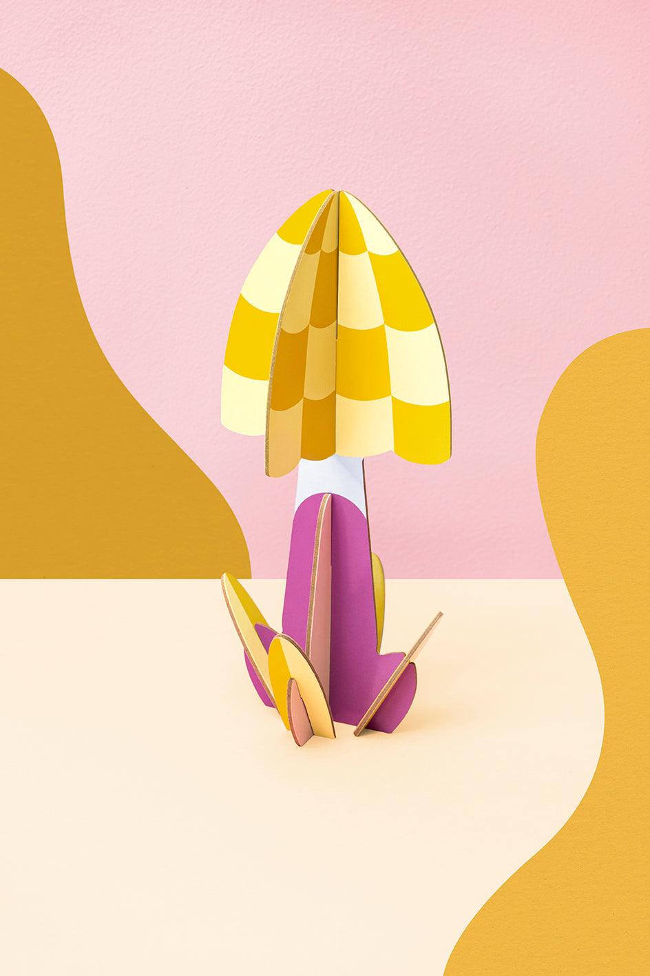 The OCTAEVO Mushroom Paper Sculpture — Yellow & Purple is displayed against a pink and gold abstract background.