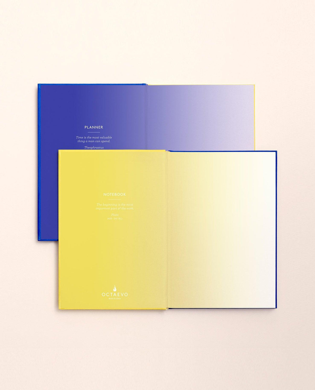 Two OCTAEVO Notebook Planners with lay-flat binding, one blue and one yellow, on a beige background.