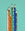 Six vibrant Octaevo NOMAD pencils arranged in a row on teal, each one eye-catching and colorful.