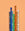 Six Octaevo NOMAD pencils with geometric patterns and gold text stand upright on a peach background.