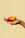 A hand holds the Octaevo Prickly Pear Candle, a playful tabletop decor piece, against a beige background.