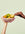 Two hands hold OCTAEVO’s Sicilia Ceramic Basket; one reaches in to take a pear from the decorative piece.