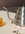 A pink OCTAEVO Sicilia Ceramic Trivet holds a gooseneck kettle near a yellow glass and coffee beans on beige.